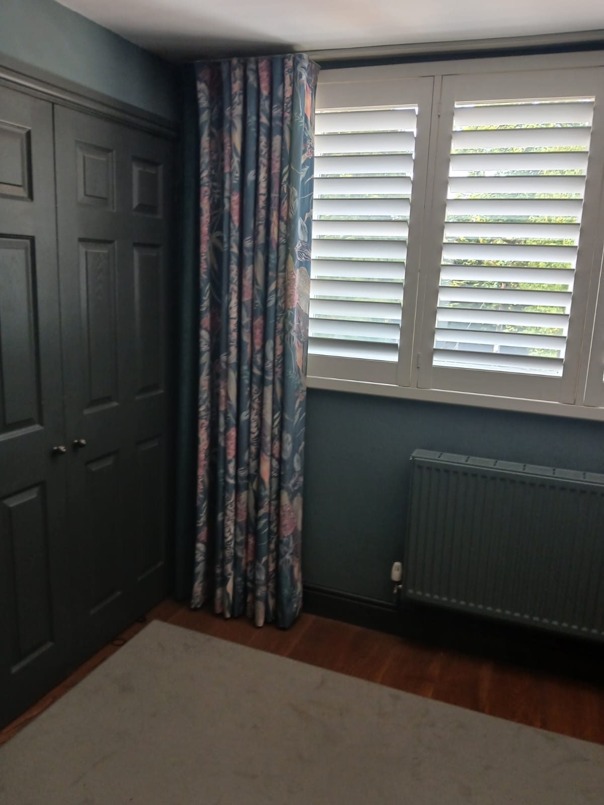 Matching curtains and shutters in bedroom